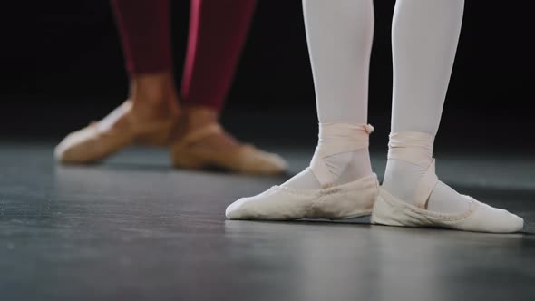 Unrecognizable Student Ballerina Repeats Movements After Teacher Spin Foot