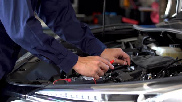 mechanics hand check electrical wiring vehicle system in car service