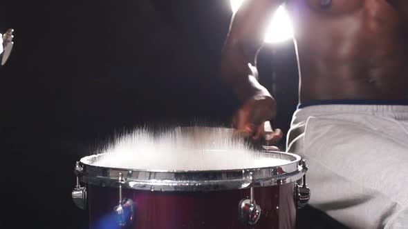 Close-up of Man's Hands Playing on Wet Drums in Music Studio