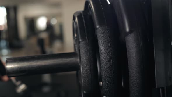 Close Up of Handsome Bodybuilder Guy Prepare to Do Exercises with Barbell in a Gym Keep Barbell