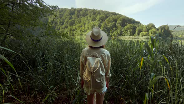 Young traveler in a hat walking in a national park