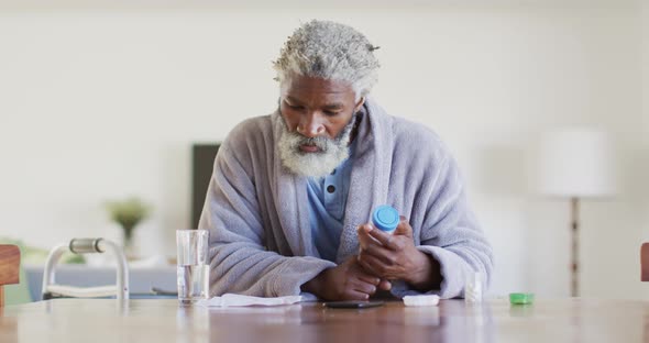 Senior man holding an empty medication container