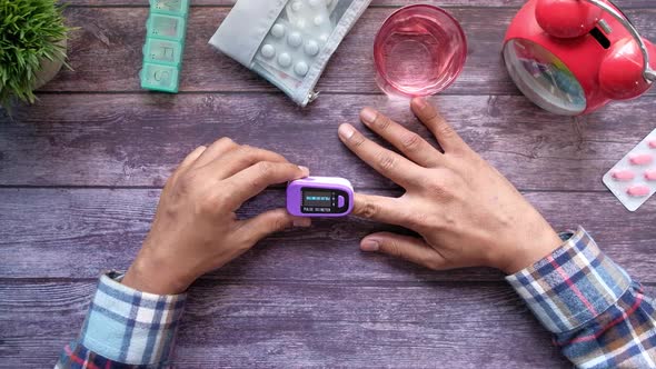 Close Up of Man Hand Using Pulse Oximeter