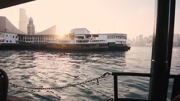 Star Ferry Pier At Tsim Sha Tsui With Clock Tower And Bright Sunset On The Background In Hong Kong. 