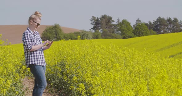 Female Farmer Using Digital Tablet in Agriculture