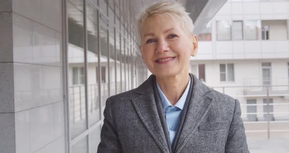 Close Up Portrait of Mature Professional Businesswoman Smiling Outdoors Business Center