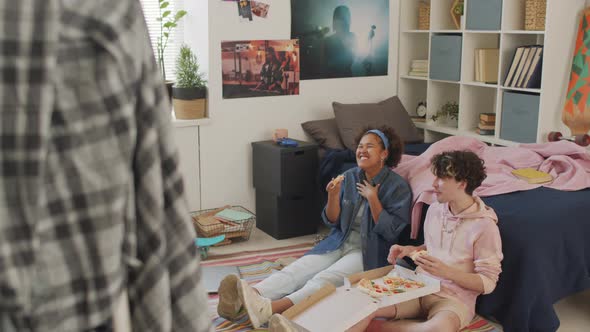 Friends Laughing and Eating Pizza