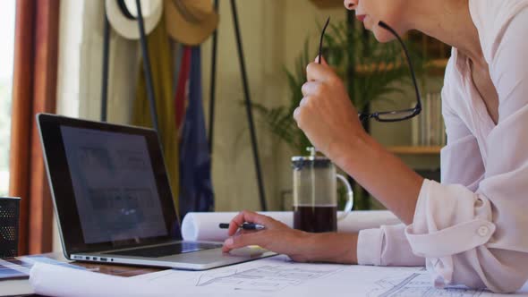 Caucasian woman using laptop, working from home