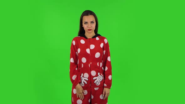 Beautiful Girl in Red Fleece Pajamas Is Waving Hand and Showing Gesture Come Here. Green Screen