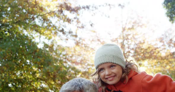 girl doing airplane with dad outdoors