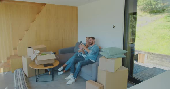 Happy Young Caucasian Pair Making Selfie with Keys From New Flat in Slowmotion. Concept of Happiness