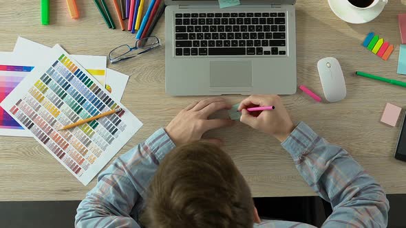 Freelancer Writing Creative on Paper and Sticking It on Laptop, Brainstorming