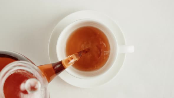 Pouring Black Tea in Cup Top View