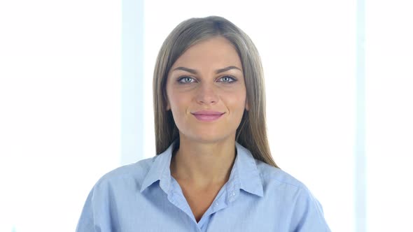 Portrait of Beautiful Young Woman Shaking Head to Accept, Yes