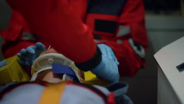 Paramedics Performing First Aid Help of Patient in Emergency Car