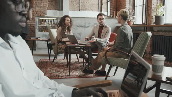 Business Partners Having Discussion in Modern Loft Coworking Space