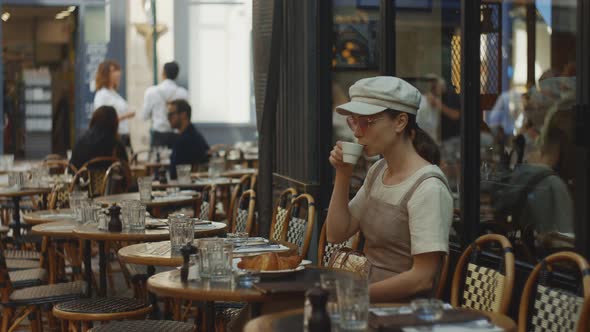 Young girl drinking coffee in a cafe