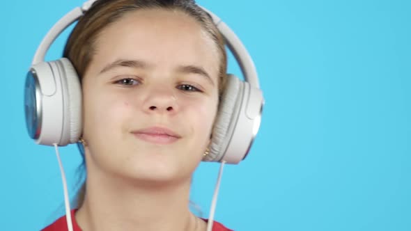 Close-up Gorgeous Kid Listening Music in Headphones. Slow Motion