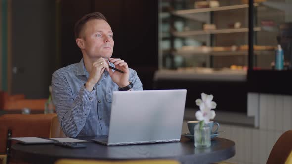 Thoughtful Serious Young Man Student Writer Sit at Home Office Desk with Laptop Thinking of