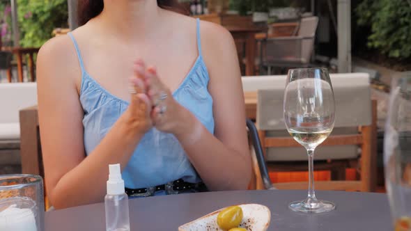 Close Up of Woman Hands Using a Hand Alcohol Gel Sanitizer Cleaning To Prevent Spread of Covid19