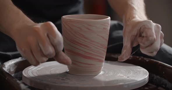 Close Up View Potter Separates the Molded Nerikomi Pot From the Potter's Wheel Pottery Workshop