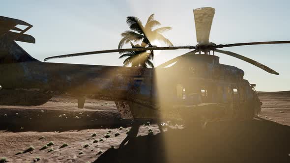 Old Rusted Military Helicopter in the Desert at Sunset alt