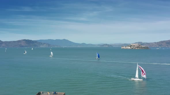 Fast Sailing Boats in the Green Waters of Pacific Ocean with Alcatraz Island