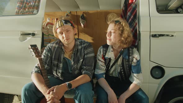 Young Man and Woman Posing for Camera in Camper Van