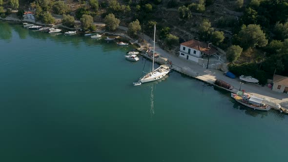 Aerial view of sailboat anchored on pier at mediterranean sea, Greece.