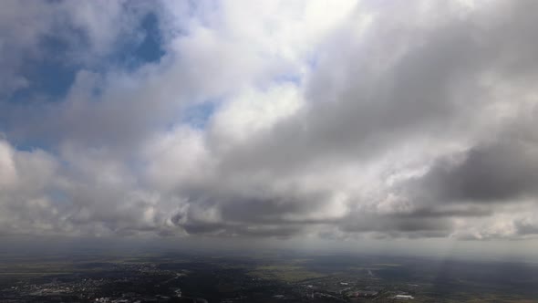 Aerial View From Airplane Window at High Altitude of Earth Covered with Puffy Cumulus Clouds Forming