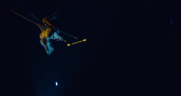 Circus Acrobat Is Performing on Stage of a Circus Swinging on a Trapeze