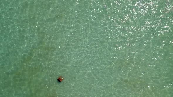 Aerial of girl swimming in crystal clear blue sea. Sao Beach, Phu Quoc, Vietnam