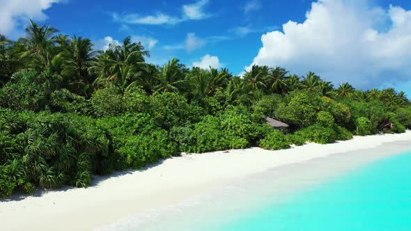 Aerial flying over sky of luxury sea view beach voyage by blue sea and white sand background of a pi