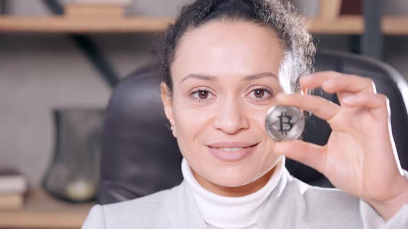 Woman Holds Symbol of Digital Currency