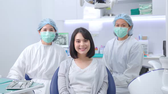 Caucasian girl patient smiling, sitting on dental chair waiting for medical service from dentist.