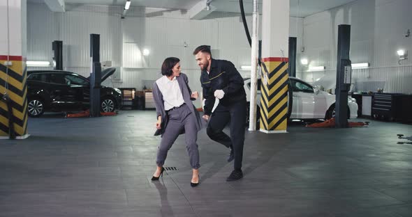 Stylish Manager Woman in a Suit and a Guy Mechanic