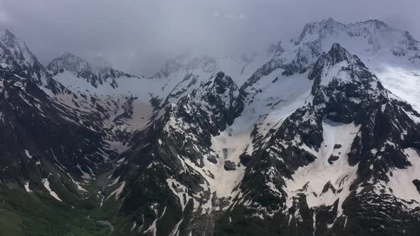 Flight above snowcapped mountains near Elbrus