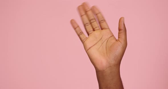 African American Man Hand Hello Gesture Isolated on Pink Background