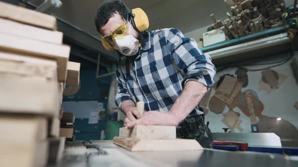 A Man Works with a Planer