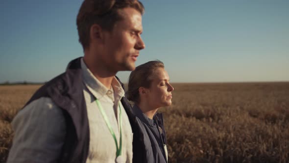 Two Farmers Walking Wheat Field Closeup