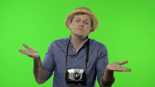 Portrait of Young Man Tourist Photographer Shrugging Shoulders, Chroma Key