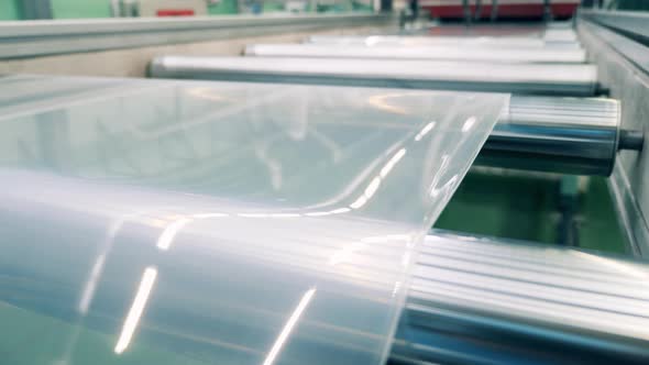 Close Up of Plastic Sheet Going Through the Factory Transporter