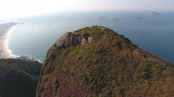 Aerial Drone Shot of Young Adults atop a Brazilian Mountain Taking in the View