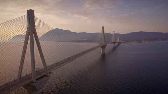 Aerial view of the Rion-Antirion Bridge at sunset in Greece.