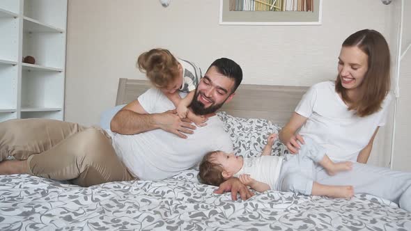 Cheerful Awesome Young Parents Spending Time with Kids