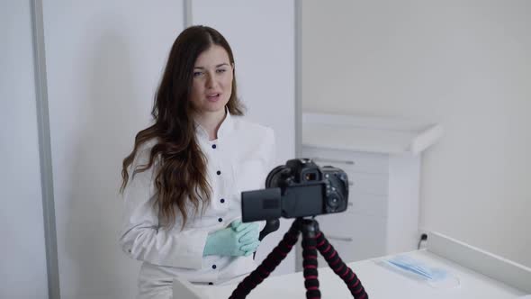 Confident Doctor in Uniform Records Video Lesson for Medical Vlog in Clinic