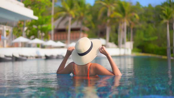 Young asian woman enjoy around outdoor swimming pool for leisure