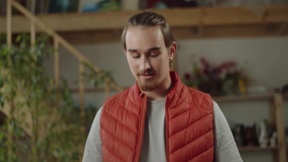 A Man is Explaining His Friends How to Carve the Top of the Halloween Pumpkin