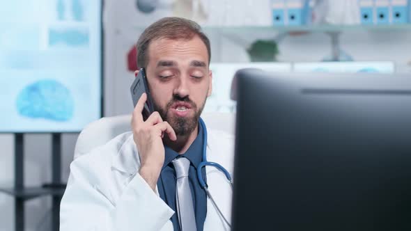 Handheld Shot of Young Doctor Having a Conversation on the Phone