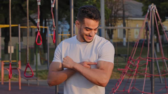Pumped Sportive Millennial Middle Eastern Arab Guy Shows Big Biceps Proud of Athletic Achievements